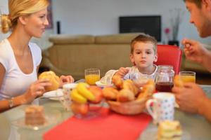 family have healthy breakfast at home photo