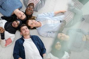 top view of a diverse group of people lying on the floor and symbolizing togetherness photo