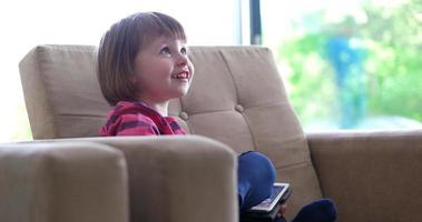 Child using tablet in modern apartment photo