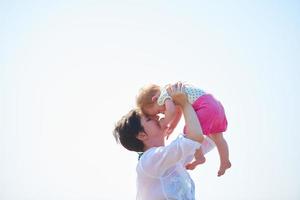 mom and baby on beach  have fun photo