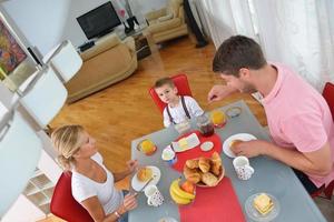 family have healthy breakfast at home photo
