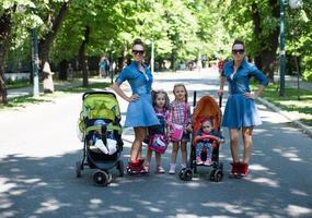 twins mother with children  in city park photo