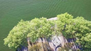 Aerial view of small island lined with trees video