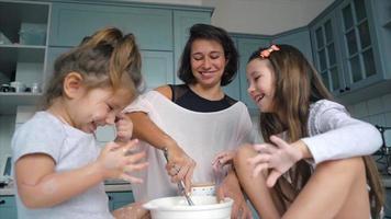 Mother and daughters making pancakes together video