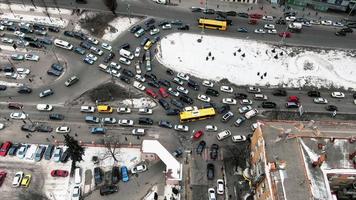 Aerial view of snowy Kyiv or Kiev city, top view of streets and cars video