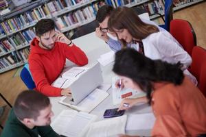 students group working on school project together on tablet computer at modern university photo