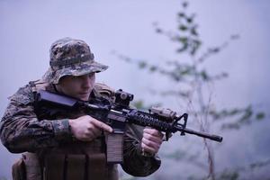 soldado en acción apuntando a la óptica de mira láser de arma foto