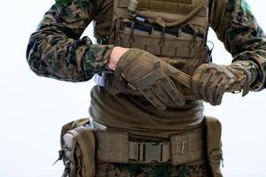 closeup of soldier hands putting protective battle gloves photo