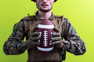 solder holding american football ball photo