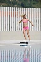 woman fitness exercise at poolside photo