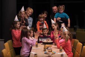 The young boy joyfully celebrating his birthday photo