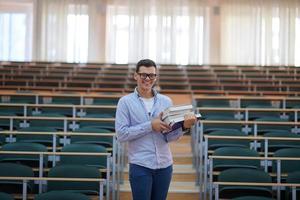 man with book in calssroom photo