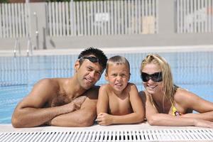 happy young family have fun on swimming pool photo