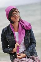 beautiful young woman on beach with scarf photo