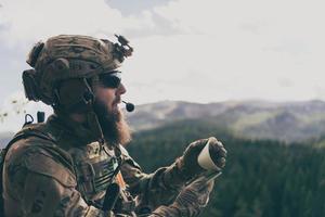 War concept. Bearded soldier in uniform of special forces in dangerous military action in dangerous enemy area studies attack tactics. Selective focus