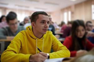 student taking notes while studying in high school photo