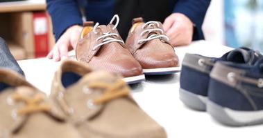 Man Chooses Shoes At Shoe Store photo