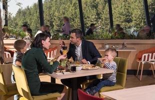 Young parents enjoying lunch time with their children photo