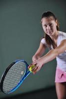 Playing tennis indoors photo