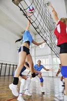 girls playing volleyball indoor game photo