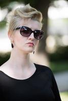 young woman with short blond hair and sunglasses photo