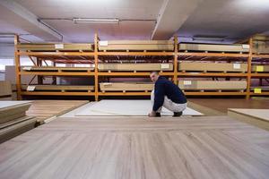 carpenter measuring wooden board photo