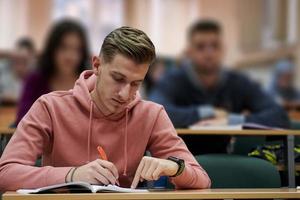 student taking notes while studying in high school photo