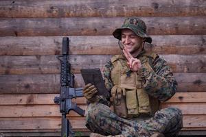 soldier using tablet computer in military camp photo