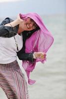 beautiful young woman on beach with scarf photo