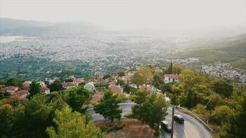 Aerial view of a high winding mountain road overlooking a city video