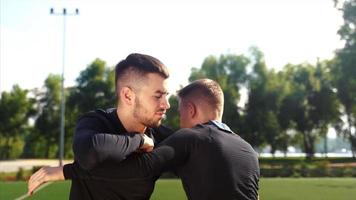 Two young men training at grass field video