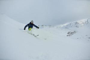 skiing on fresh snow at winter season at beautiful sunny day photo