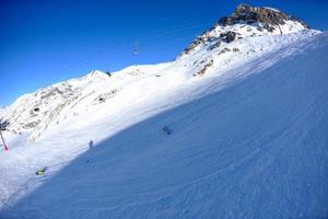 skiing on fresh snow at winter season at beautiful sunny day photo