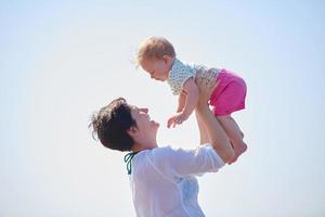 mom and baby on beach  have fun photo