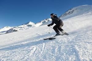 skiing on fresh snow at winter season at beautiful sunny day photo