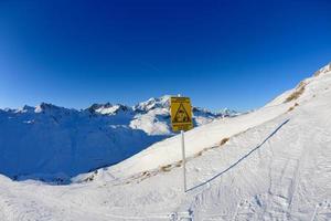 Sign board at High mountains under snow in the winter photo