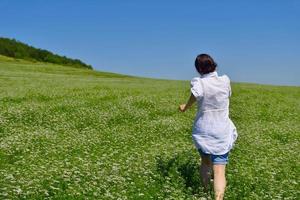 Young happy woman in green field photo