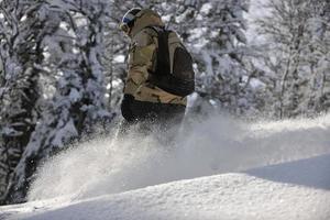 freestyle snowboarder jump and ride photo