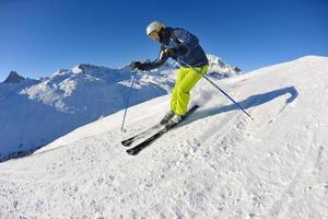 skiing on fresh snow at winter season at beautiful sunny day photo