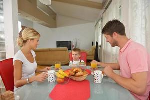 family have healthy breakfast at home photo