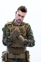 closeup of soldier hands putting protective battle gloves photo