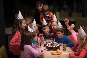 The young boy joyfully celebrating his birthday photo