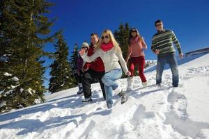 friends have fun at winter on fresh snow photo