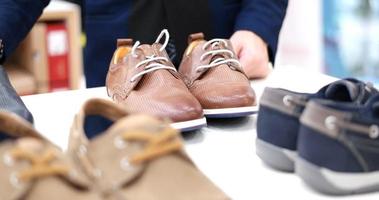 Man Chooses Shoes At Shoe Store photo