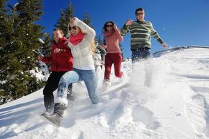 los amigos se divierten en invierno con nieve fresca foto