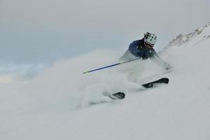 skiing on fresh snow at winter season at beautiful sunny day photo