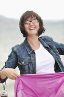 beautiful young woman on beach with scarf photo