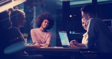 Multiethnic startup business team in night office photo