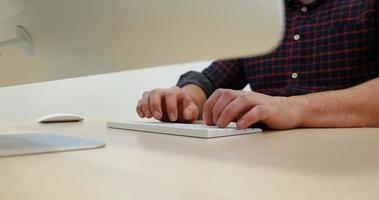 hands typing on computer keyboard in startup office photo