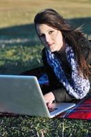 young teen girl work on laptop outdoor photo